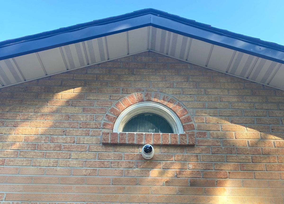 Home surveillance camera mounted on front of Hamilton home by local security company Open Road Systems Inc. 
